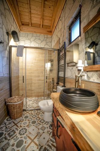 a bathroom with a sink and a toilet at Pino Mar Luxury Bungalows in Erdek