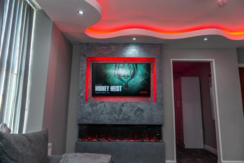 a living room with a wall with a fire place at Meridian Serviced Apartments in Bradford