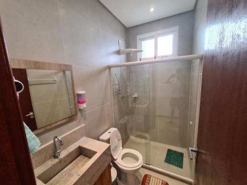 a bathroom with a sink and a toilet and a shower at Vilage novo praia do forte 3 in Mata de Sao Joao