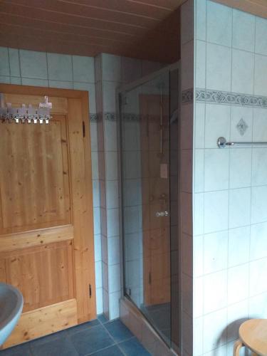 a bathroom with a glass shower and a sink at Fronwieshäusl Gschoßmann Johanna in Ramsau