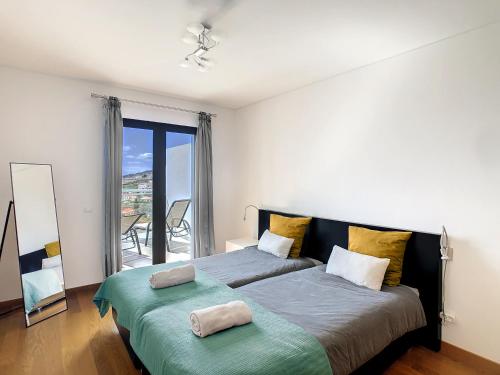 a bedroom with a large bed with two pillows on it at Heaven I by LovelyStay in Caniço