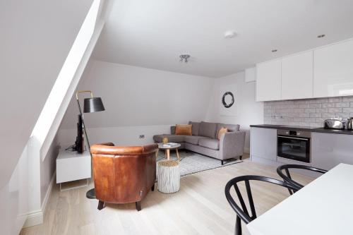 a living room with a couch and a table at 7VH Virginia House, 31 Bloomsbury Way By City Living London in London