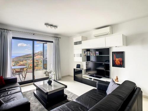 a living room with a couch and a table at Heaven I by LovelyStay in Caniço