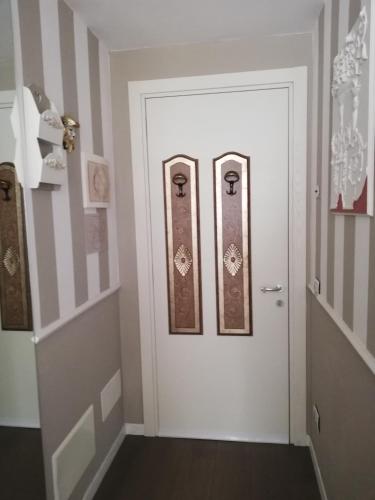 a white door with two pictures on it at B & B San Domenico in Chioggia
