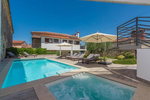 a swimming pool in the backyard of a house at Villa Artiana in Rovinjsko Selo