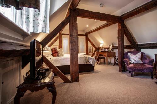 a bedroom with a large bed and a large window at The White Hart Royal, Moreton-in-Marsh, Cotswolds in Moreton in Marsh
