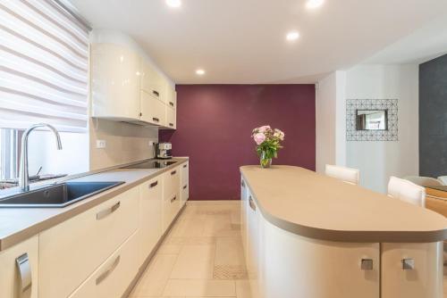 a kitchen with a sink and a vase of flowers on a counter at Villa Artiana in Rovinjsko Selo