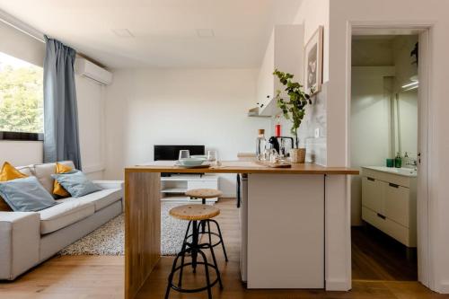 a kitchen and living room with a couch and a table at Stylish and Elegant Studio - Best View and Location in Coimbra Downton in Coimbra