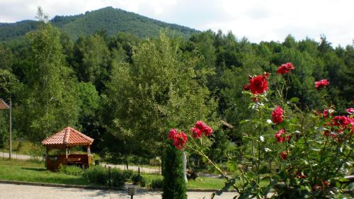 a gazebo in a park with flowers and trees at Hotel Perfect in Yamna