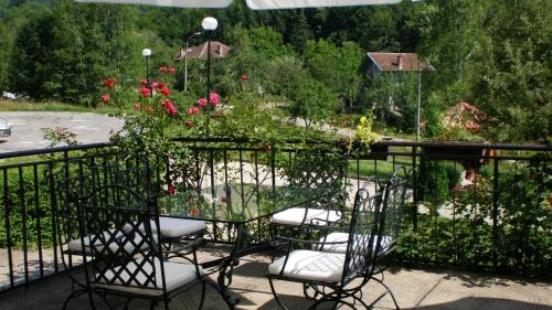 a patio with chairs and a table with flowers at Hotel Perfect in Yamna