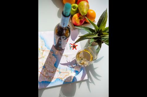 a bottle of wine and a map and fruit at Apartments Urban Arrecife in Arrecife