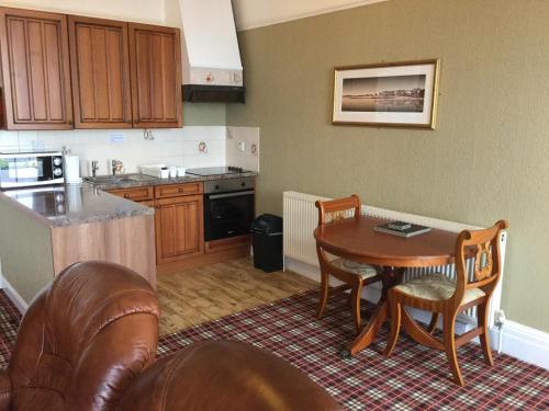a kitchen with a table and a table and chairs at Eden Vale First Floor Sea View Apartment in Morecambe