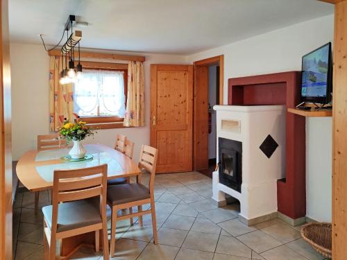 a dining room with a table and a fireplace at Elto Wagau in Fusch an der Glocknerstraße