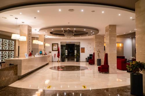 a lobby of a hotel with a reception at Hôtel Tamuda Beach in M'diq