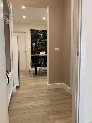 a hallway with a dining room and a dining table at Pompei Luxury Suite in Pompei