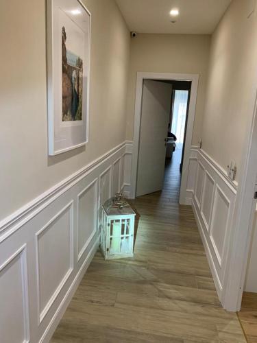 a hallway with a table in the middle of a room at Pompei Luxury Suite in Pompei