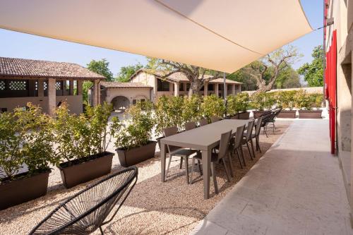 a table and chairs under an umbrella on a patio at Borgo di Drugolo in Lonato del Garda