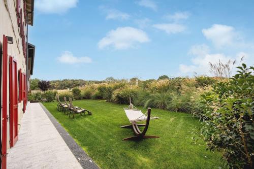 a row of benches sitting on the grass next to a building at Borgo di Drugolo in Lonato del Garda