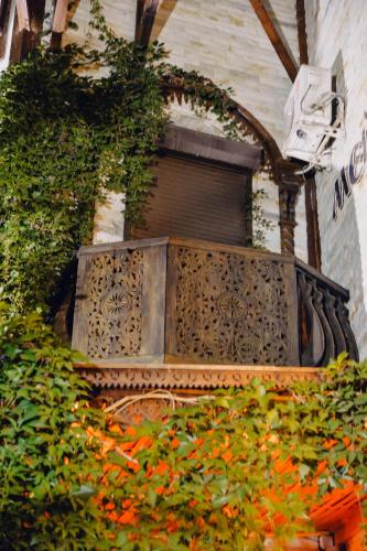 a building with a window and some plants at Metelitsa Hotel in Karagandy