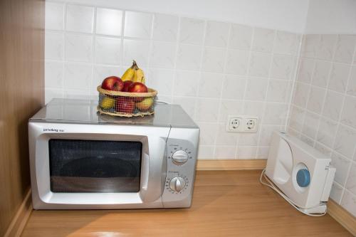 a bowl of fruit on top of a microwave at Haus Bott in Hilders