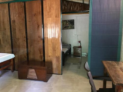 a room with a wooden door and a bedroom at Kamp Kamouflage Kanha in Kānha