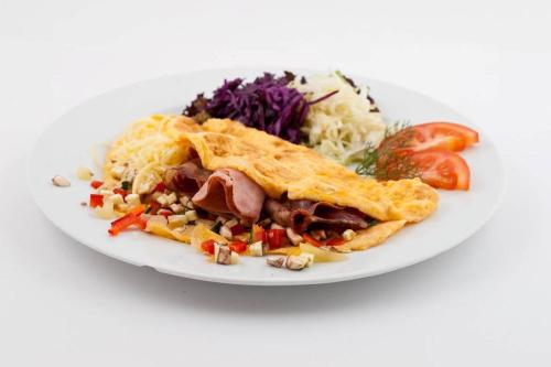 a white plate of food with a plate of food at Aparthotel Miramare in Makarska