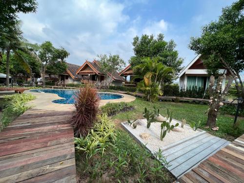a villa with a swimming pool in a resort at Siri Lagoona Resort in Nong Prue