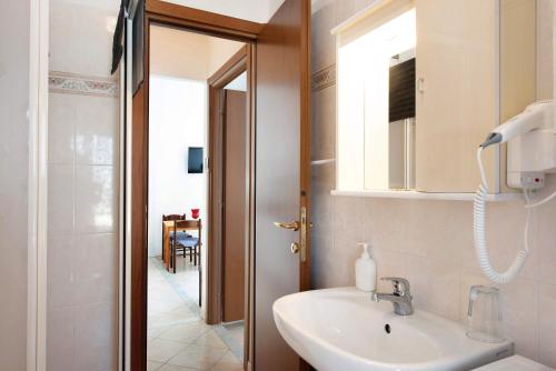 a bathroom with a sink and a mirror at Trilocale San Nazario in Varazze