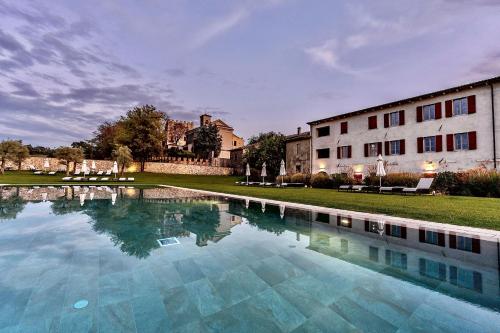 a large swimming pool in front of a building at Borgo di Drugolo in Lonato