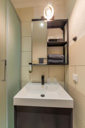 a bathroom with a white sink and a mirror at Hof Ehrenfels in Mainz