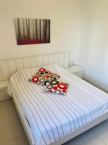 a bed with two pillows on it in a room at Portobello Verena in Port de Pollensa