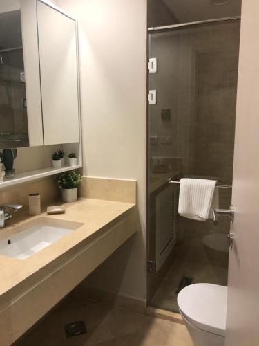a bathroom with a sink and a shower and a toilet at Jutta Deluxe 2-Bedroom-Apartment Mangroovy-M7 El Gouna in Hurghada