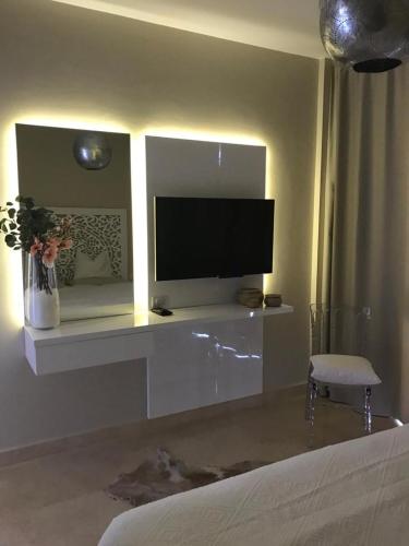 a living room with a flat screen tv on a wall at Jutta Deluxe 2-Bedroom-Apartment Mangroovy-M7 El Gouna in Hurghada