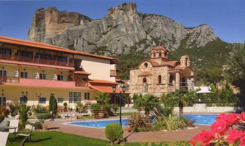 a hotel with a mountain in the background at Famissi Eden Hotel in Kalabaka