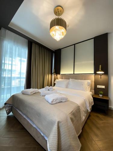 a bedroom with a large bed with towels on it at FILEO ELEGANT LIVING in Veria