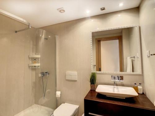 a bathroom with a sink and a toilet and a shower at Samya Apartment by LovelyStay in Funchal