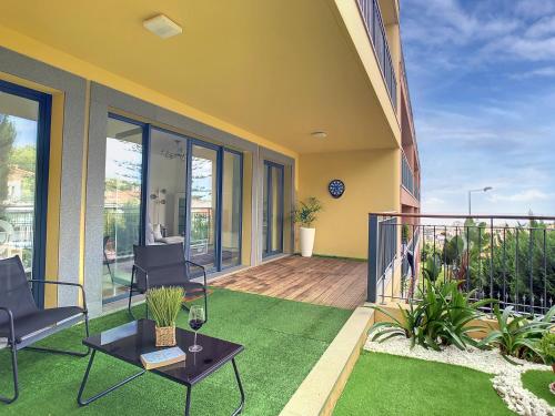 a patio with a table and chairs on a balcony at Samya Apartment by LovelyStay in Funchal