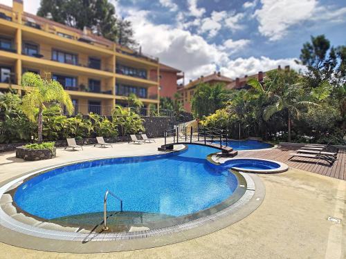 a large swimming pool in front of a building at Samya Apartment by LovelyStay in Funchal