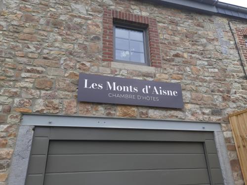 a sign above a garage door on a brick building at Les Monts d'Aisne in Mormont