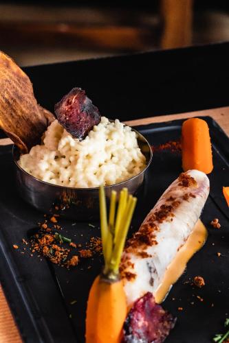 a plate of food with rice and meat and carrots at ibis Styles Castelnaudary in Castelnaudary