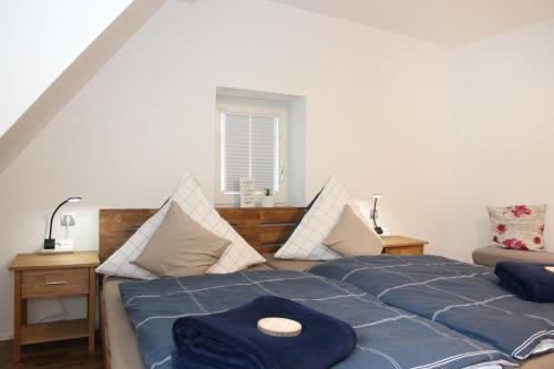 a bedroom with two beds with blue sheets at Ferienwohnung Blum in Schmallenberg