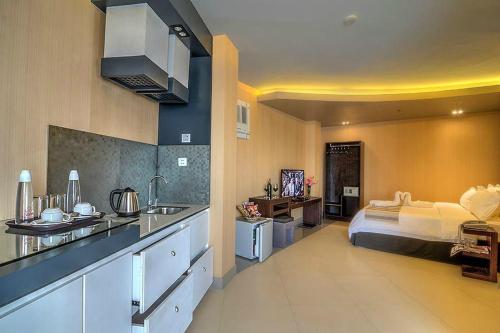 a kitchen and a bedroom with a bed in it at Eloisa Royal Suites in Mactan