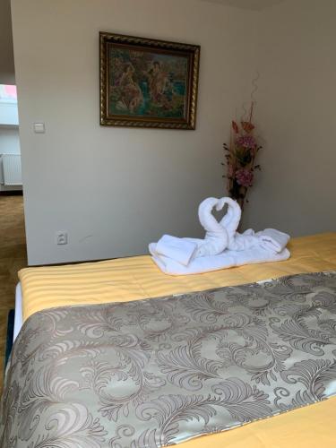 a hotel room with a bed with two towels at Penzión Deloris in Trenčín