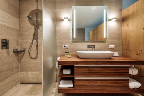 a bathroom with a sink and a shower at Luxury Panorama apartment with AlpenGold Spa Access in Davos