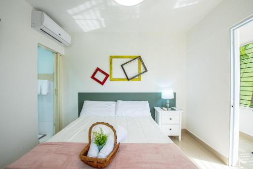 a bedroom with a bed with a basket on it at Bamboo Hoouse in Santo Domingo