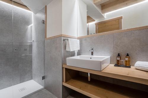 a bathroom with a sink and a shower at Chalet Alpenrose in Misurina