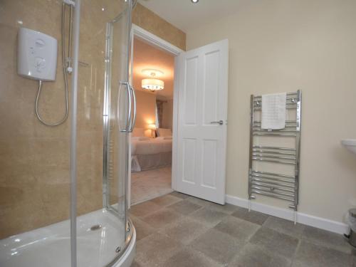 a bathroom with a shower and a walk in shower at Pengarreg Fawr in Aberystwyth