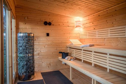 a sauna with a bench in a wooden wall at Liebevoll hinterm Deich in Lehe