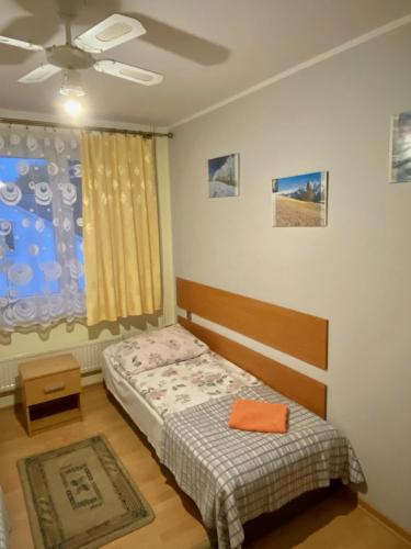 a bedroom with a bed and a ceiling fan at Hotelik Gościnny in Radzyń Podlaski