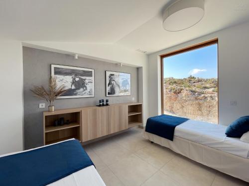 Giường trong phòng chung tại Colina del Sol Cullera - Villa Luna